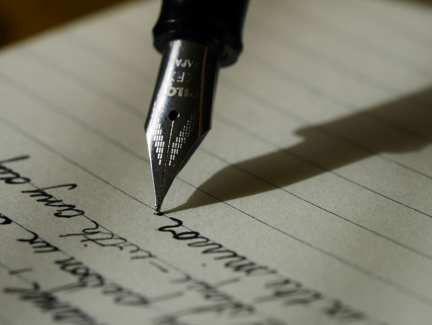 A fountain pen resting on handwritten notes